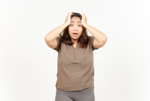 A woman is holding her head and looking at the camera photo