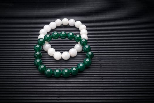 Close-up of two Jade bangles or bracelets on a black background photo