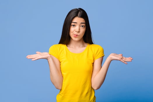 I Don't Know. Careless Asian Girl Shrugging Shoulders Over Purple Studio Background, Copy Space photo