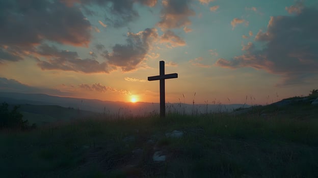 Scenic view with a religious cross silhouetted against a sunrise over rolling hills backdrop photo