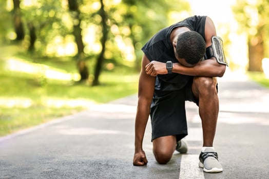 Upset african american sportsman standing on park path, feeling lost photo