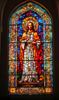 Exquisite stained glass art portraying a divine figure in vibrant kaleidoscopic colors photo