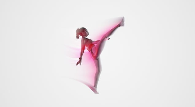 Motivated African American lady doing karate kick move, sporty woman raising leg and showing perfect stretching, woman training self-defense over blue studio background, full length photo