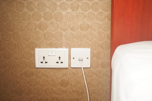 Wall outlets near bed in a modern hotel room during daylight photo