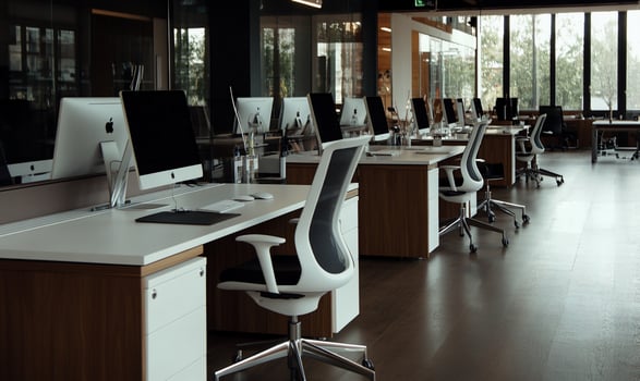 Modern, empty office space with rows of desks photo