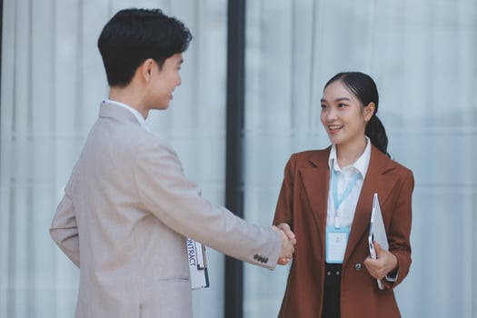 Asian businesswoman and man shaking hands photo