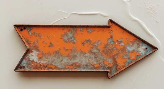 An old rusty metal sign with an arrow pointing to the right photo
