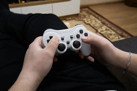 Playing game on console. Gaming game play on tv monitor. Gamer concept. Young boy hand with joystick at home photo