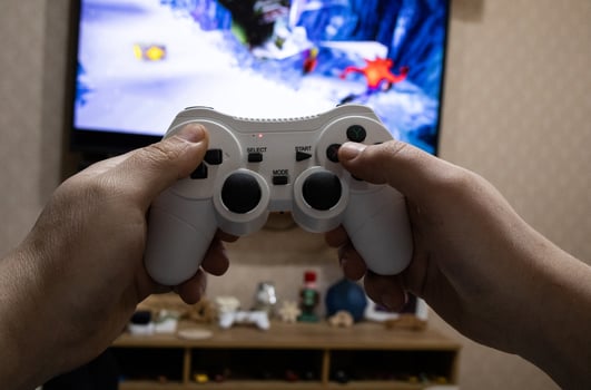 Playing game on console. Gaming game play on tv monitor. Gamer concept. Young boy hand with joystick photo