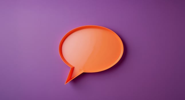 Orange speech bubble on a purple background. photo