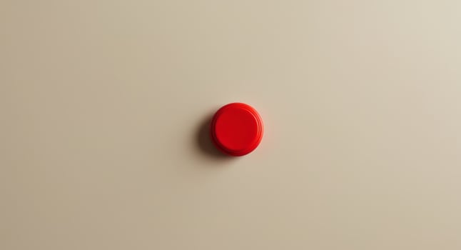 Close up of a Small Red Plastic Calculator Button on a Beige Background. photo