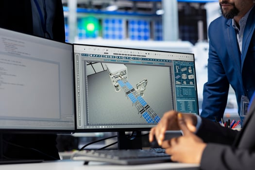 Solar panel manufacturing plant manager checking progress done by technician programming industrial systems developing tools to track and improve equipment performance, close up photo