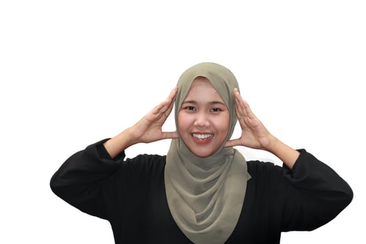 Smiling Muslim Woman in Hijab with Hands Near Face photo