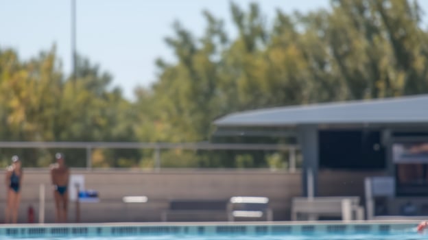 Summer swimming activity at a public pool with participants enjoying a sunny day photo