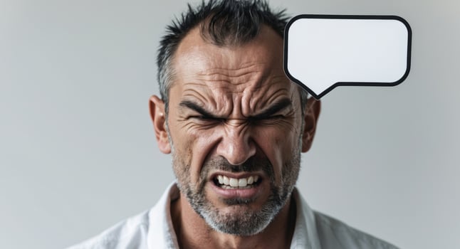 Angry Man Holding Blank Speech Bubble for Message or Announcement. photo