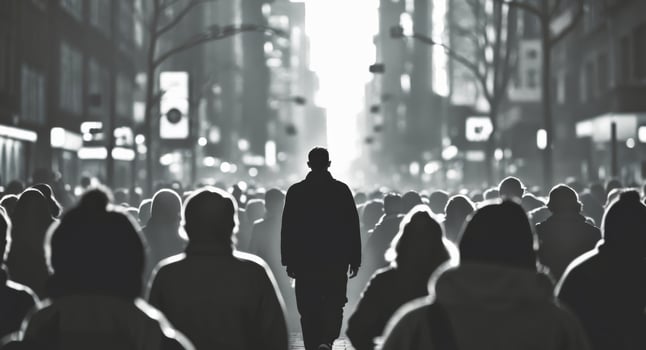 A silhouette of a person walking forward in a crowd. photo
