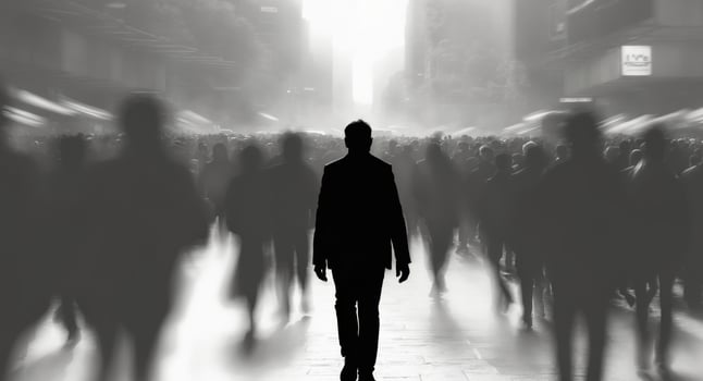 A silhouette of a person walking forward in a crowd photo