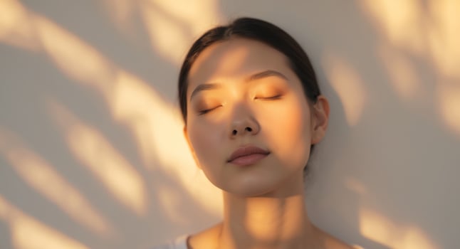 Capturing tranquility in golden hour light with a serene gaze and soft shadows. photo