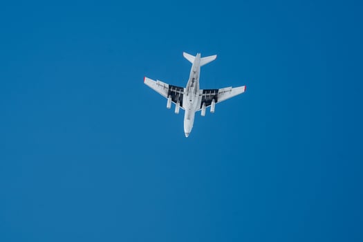 An airplane is gracefully flying through a clear, vibrant blue sky, showcasing the beauty of daytime aviation and the marvel of fixedwing aircraft in the world of air travel photo