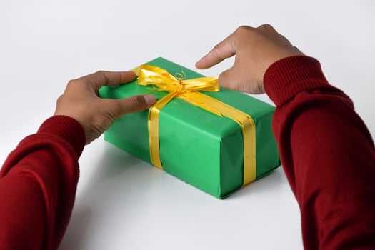 Two Hands Unraveling a Bright Yellow Ribbon photo