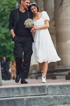 Beautiful bride with his fiance is celebrating wedding outdoors photo