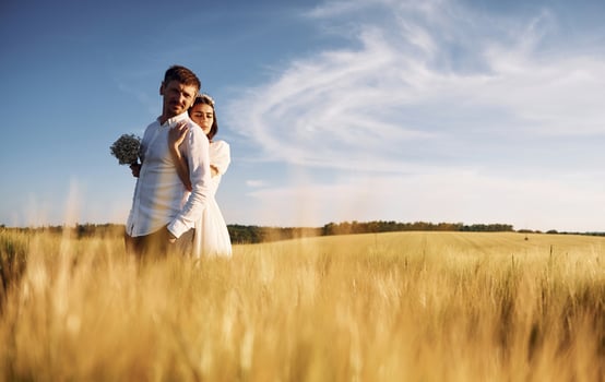 Beautiful sunlight. Couple just married.. Together on the majestic agricultural field photo