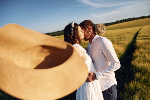 Happy people. Couple just married. Together on the majestic agricultural field at sunny day.. photo