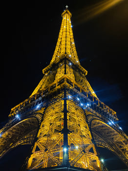 Paris, France - April 30, 2024 - Illuminated Eiffel Tower in Paris at night showcasing its metallic architecture photo