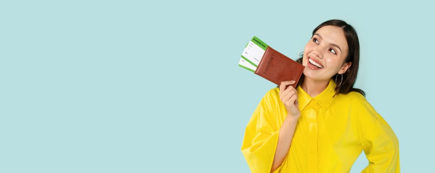 Travel Tour Offer. Excited Tourist Young Brunette Woman Holding Boarding Pass And Passport Standing Over Blue Background, Glad About New Vacation Journey, Advertising Cheap Flight Tickets photo