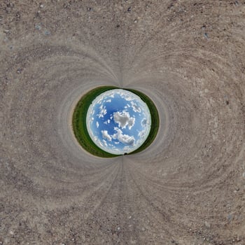 A circular view of a planet with a blue sky photo