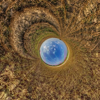 A view of a circular field with grass and sky photo