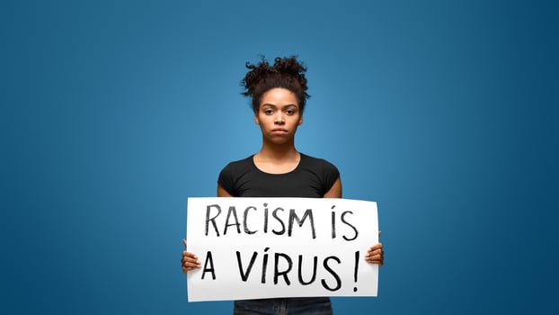 Racism is a Virus. Black girl holding banner for protest, rally or awareness campaign against racial discrimination of dark skin color. photo