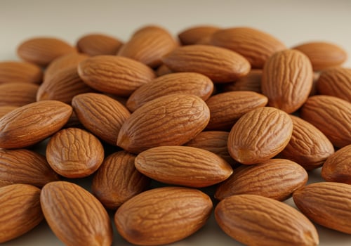 A tightly arranged pile of shelled almonds showcases their warm, inviting texture and wholesome appeal photo