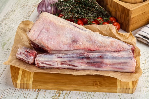 A piece of meat on a cutting board with a knife and a knife photo