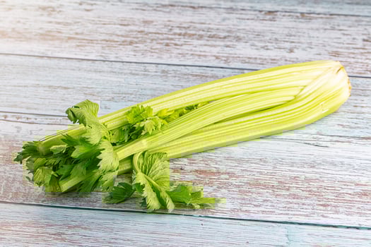A celery stalk on a wooden table photo