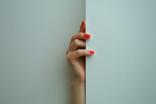 A woman's hand with red manicure sexily hugs a white empty wall. Generated by artificial intelligence photo