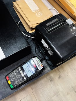 Kyiv, Ukraine - March 10, 2025- Point-of-sale terminal and receipt printer system on a cashier counter photo