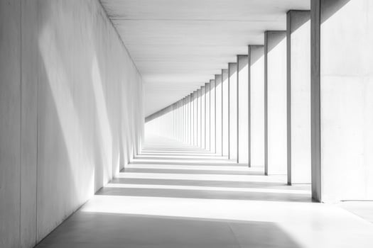 A minimalist corridor with geometric columns and shadows, creating a sense of depth and perspective. photo
