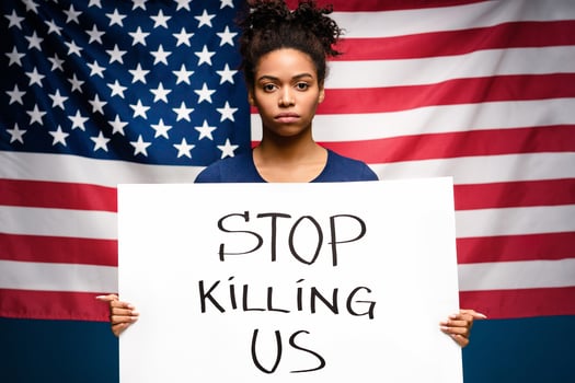 Black lives matter. Black woman protesting with demonstration placard, american flag background photo