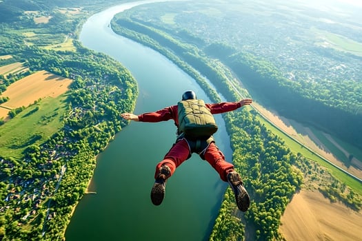 Skydiver flying over beautiful river and landscape during sunny day photo