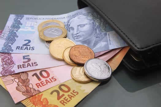 Brazilian Real Bills and Coins Inside a Black Wallet photo