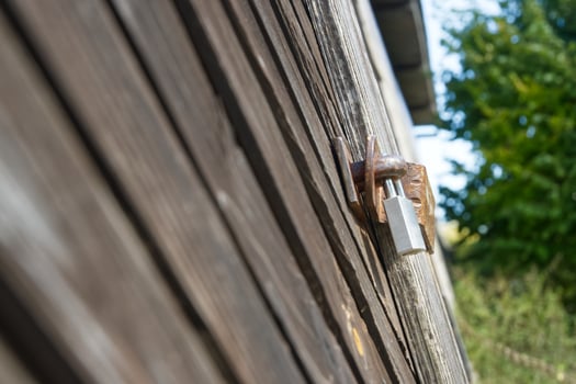 Close up of a Padlock on a Wooden Wall photo