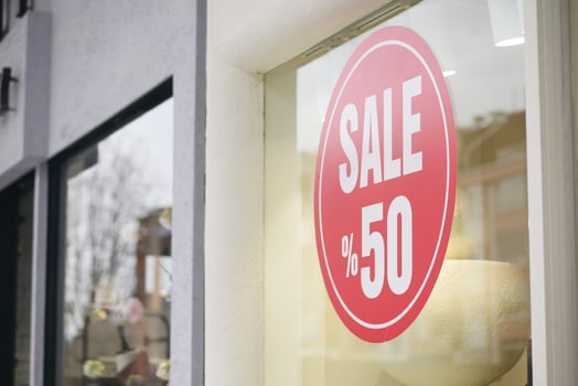Sale sign displaying fifty percent discount in retail store photo