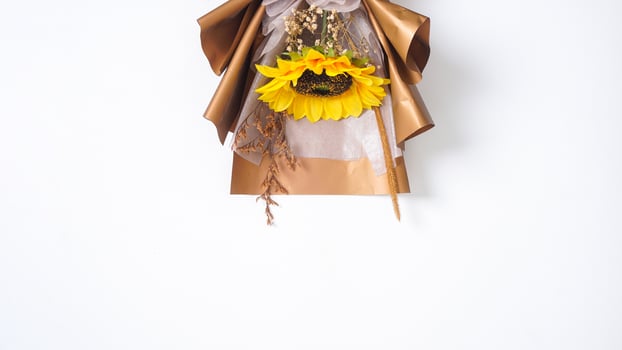 Beautiful artificial single sunflower in paper craft bouquet isolated on white background photo