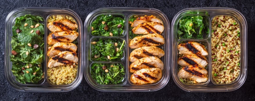 Healthy meal prep inspiration concept. Healthy meal prep with grilled chicken, greens, and grains in containers. photo