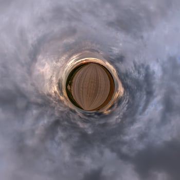 A circular view of a field with clouds photo