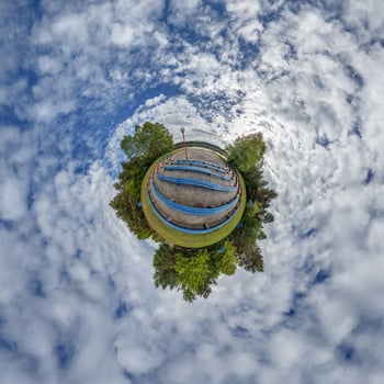 A small planet with a blue bench in the middle photo