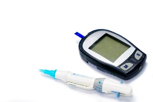 Accu-Chek Fastclix and glucose meter with sheet check isolate on white background. photo