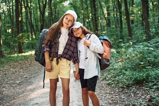 Front view.. Two girls ,is in the forest having a leisure activity, discovering new places photo