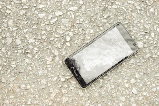 Top view black mobile phone accident fall to the road and glass broken on road background with natural sun light. photo